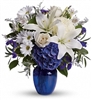 Lush blue hydrangeas, creamy crÃ¨me roses, pure white lilies, delicate alstroemeria, and fresh white chrysanthemums, this bouquet is complemented by fragrant eucalyptus, airy Limonium, and other seasonal greenery for a full, luxurious display.