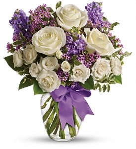 With its elegant mix of white roses, spray roses, lavender stock, and delicate waxflower, this bouquet is a heartfelt gift thatâ€™s sure to be cherished.