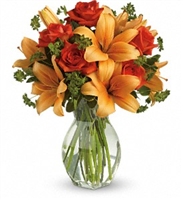 Firey Lily and Rose arrangement with orange Asiatic lilies and orange roses in a clear glass vase Firey Lily and Rose arrangement with orange Asiatic lilies and orange roses in a clear glass vase